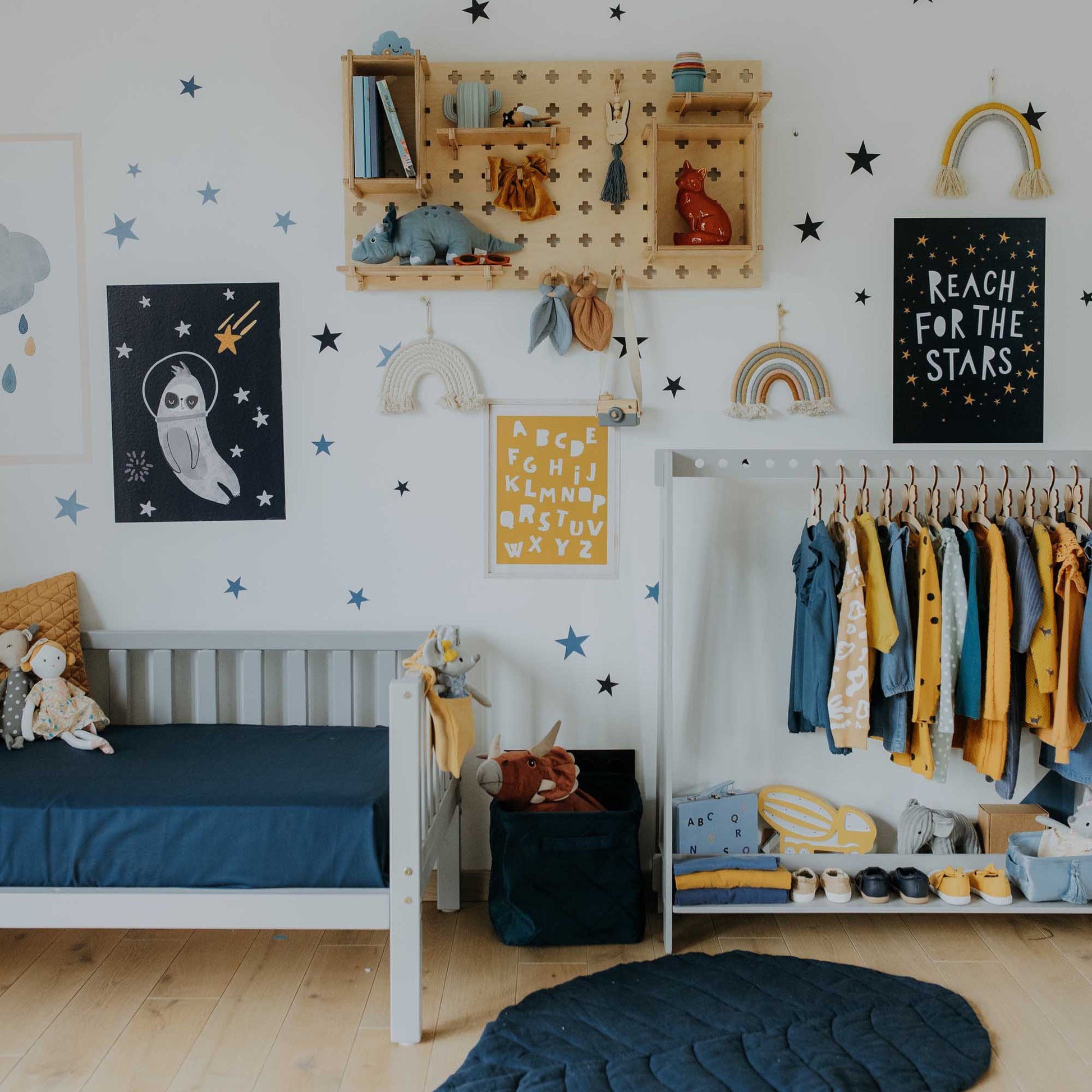 A boy's room with blue and yellow decor featuring Sweet HOME from wood's Pegboard Wall Shelf open storage shelves.