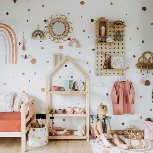 A child's room with polka dot walls and Sweet HOME from wood Floating Shelves Pegboard.