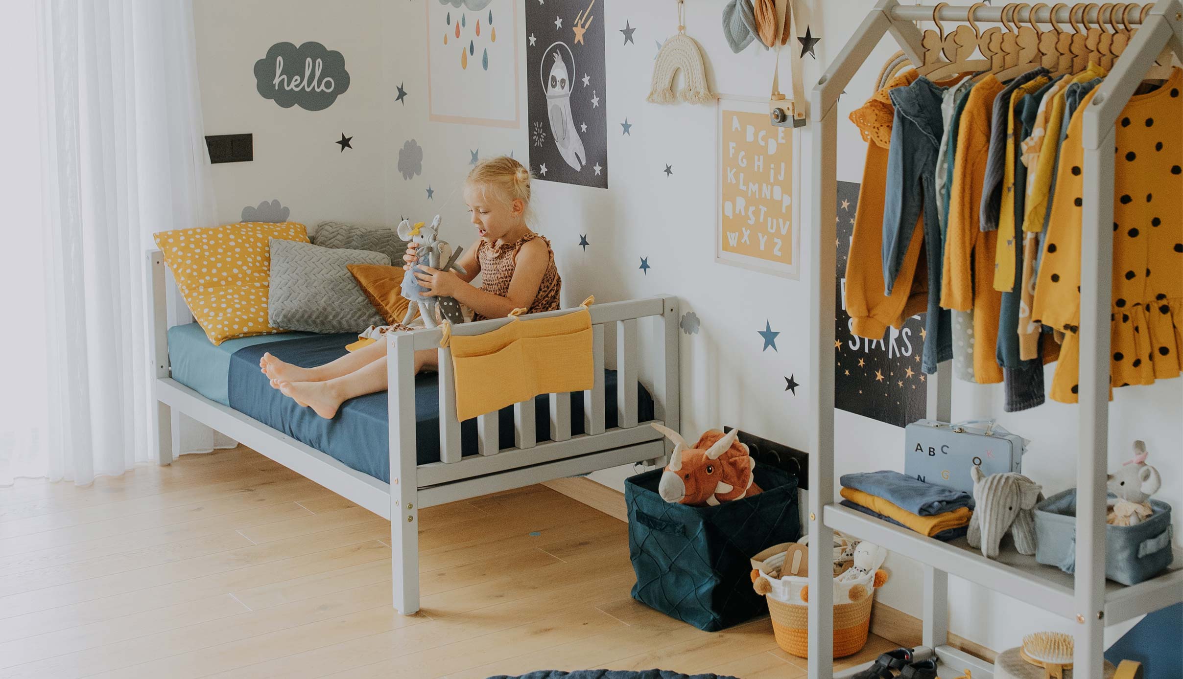 A child's bedroom with a yellow and blue theme.