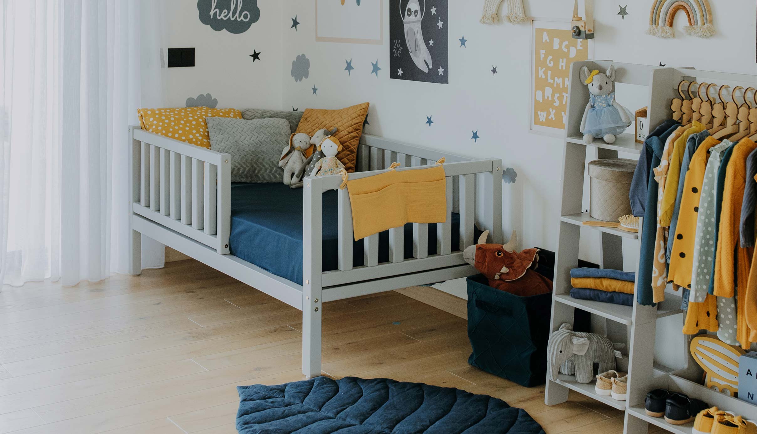 A baby's room with yellow and blue decor.