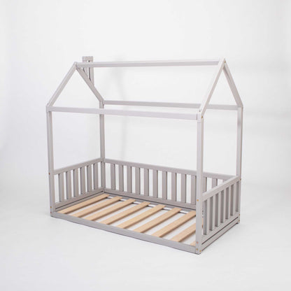 A cozy Sweet Home From Wood Montessori House Bed made of grey wooden slats, perfect for creating a preschool bed or a snug sleep haven.