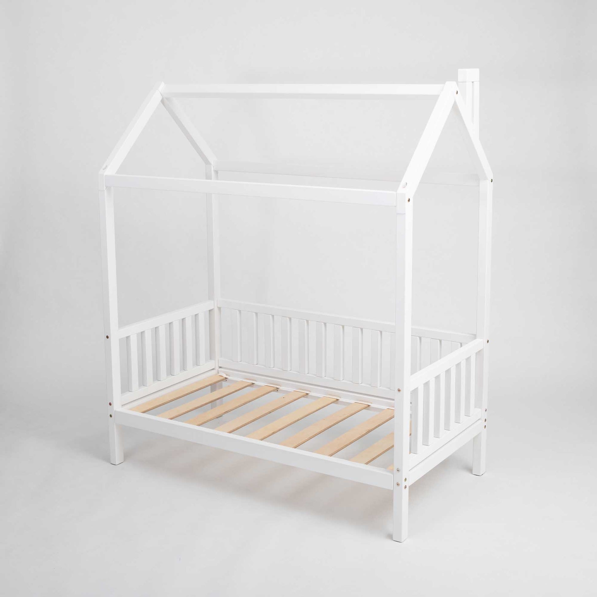 A raised white raised house bed on legs with 3-sided rails.