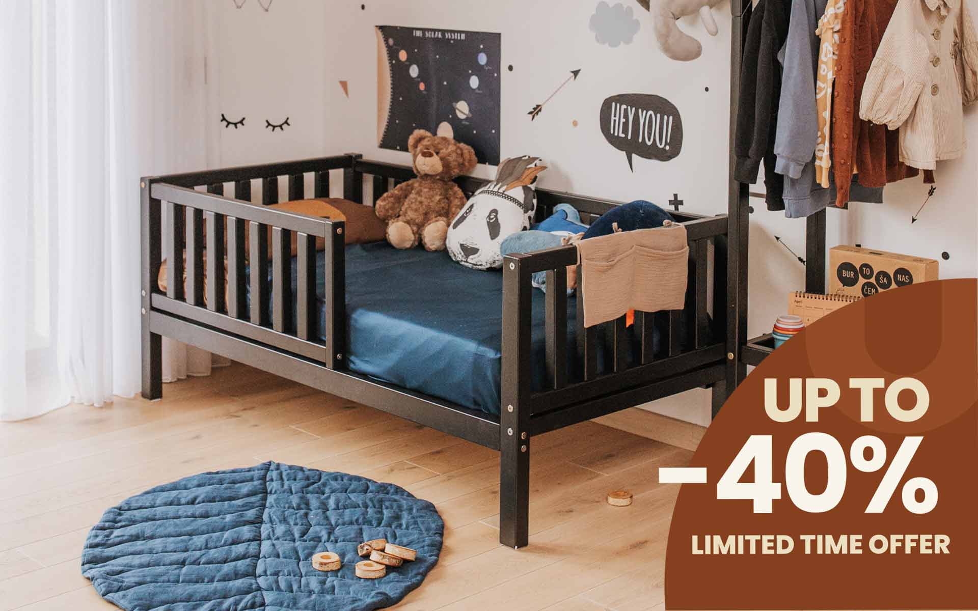 Raised toddler bed with rails around four sides in a boys room.