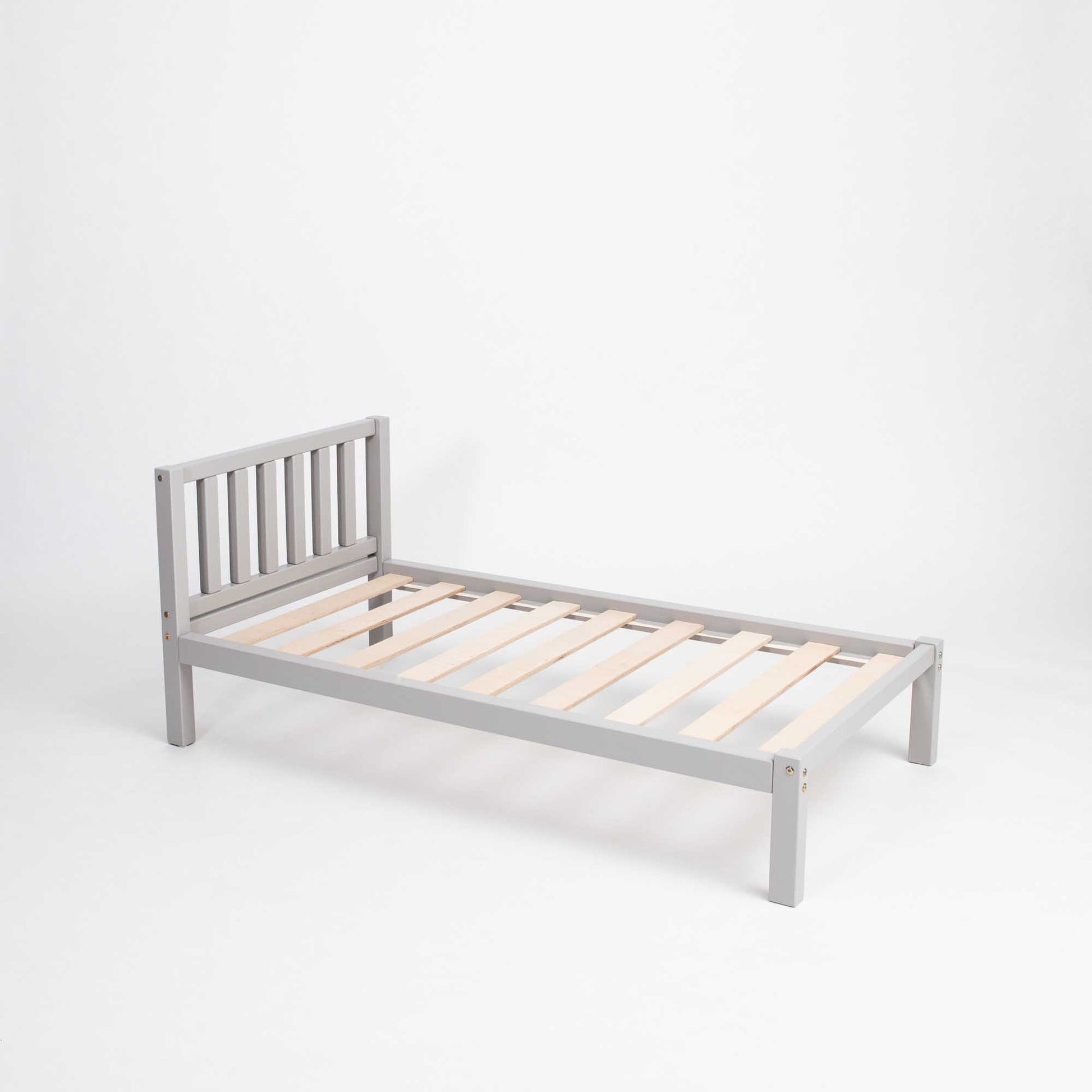 A Sweet Home From Wood Kids' bed on legs with a headboard, perfect for children who seek independence and follow Montessori principles.