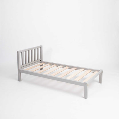 Kids' bed on legs with a headboard