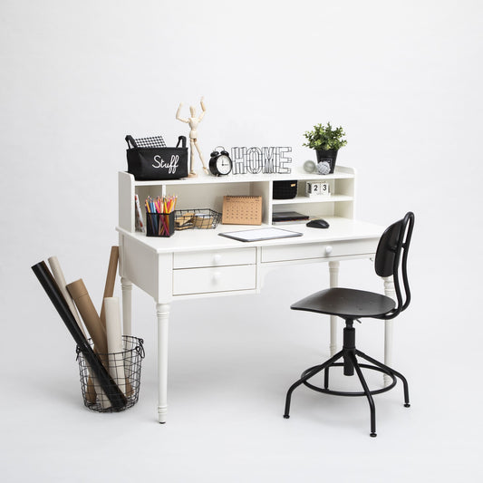 A well-organized white Table with a hutch, Pedestal desk with shelves, a laptop, decorative items, and a black chair against a plain background.