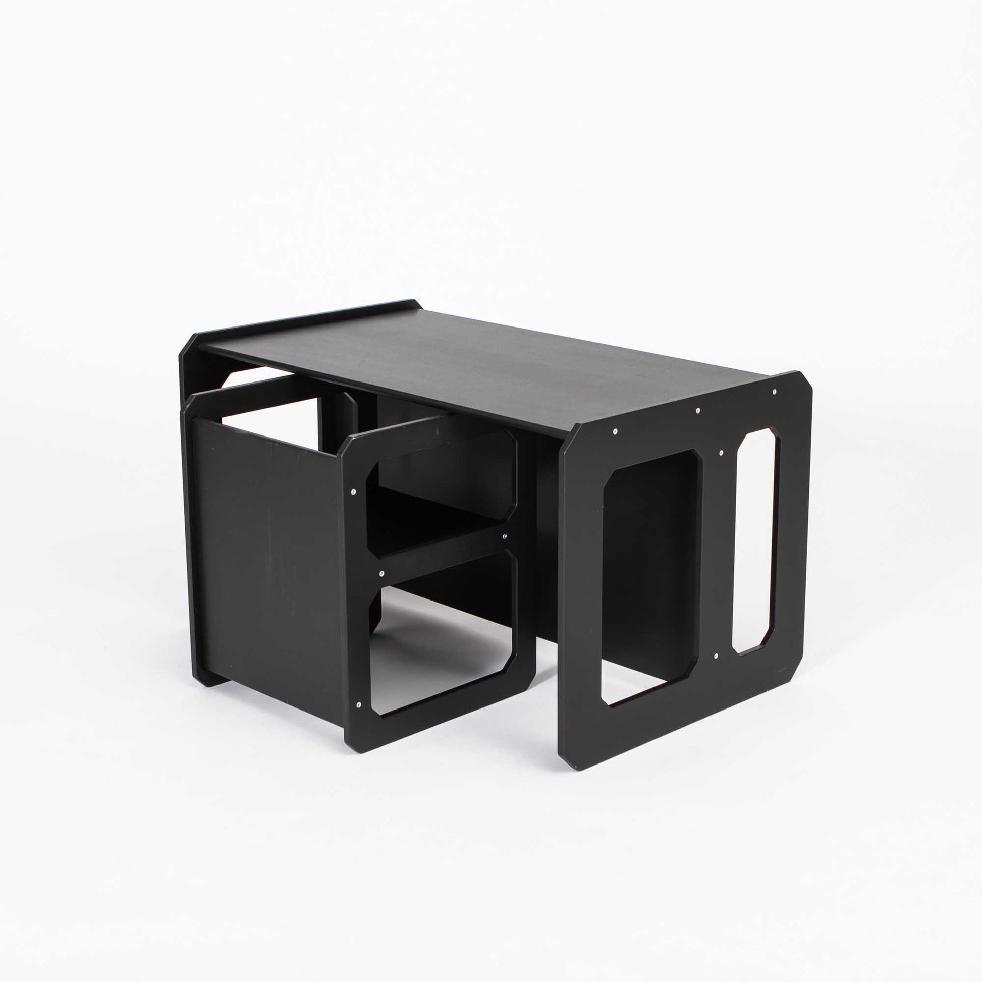 A black Sweet Home From Wood Montessori weaning table and chair set with a shelf on it.