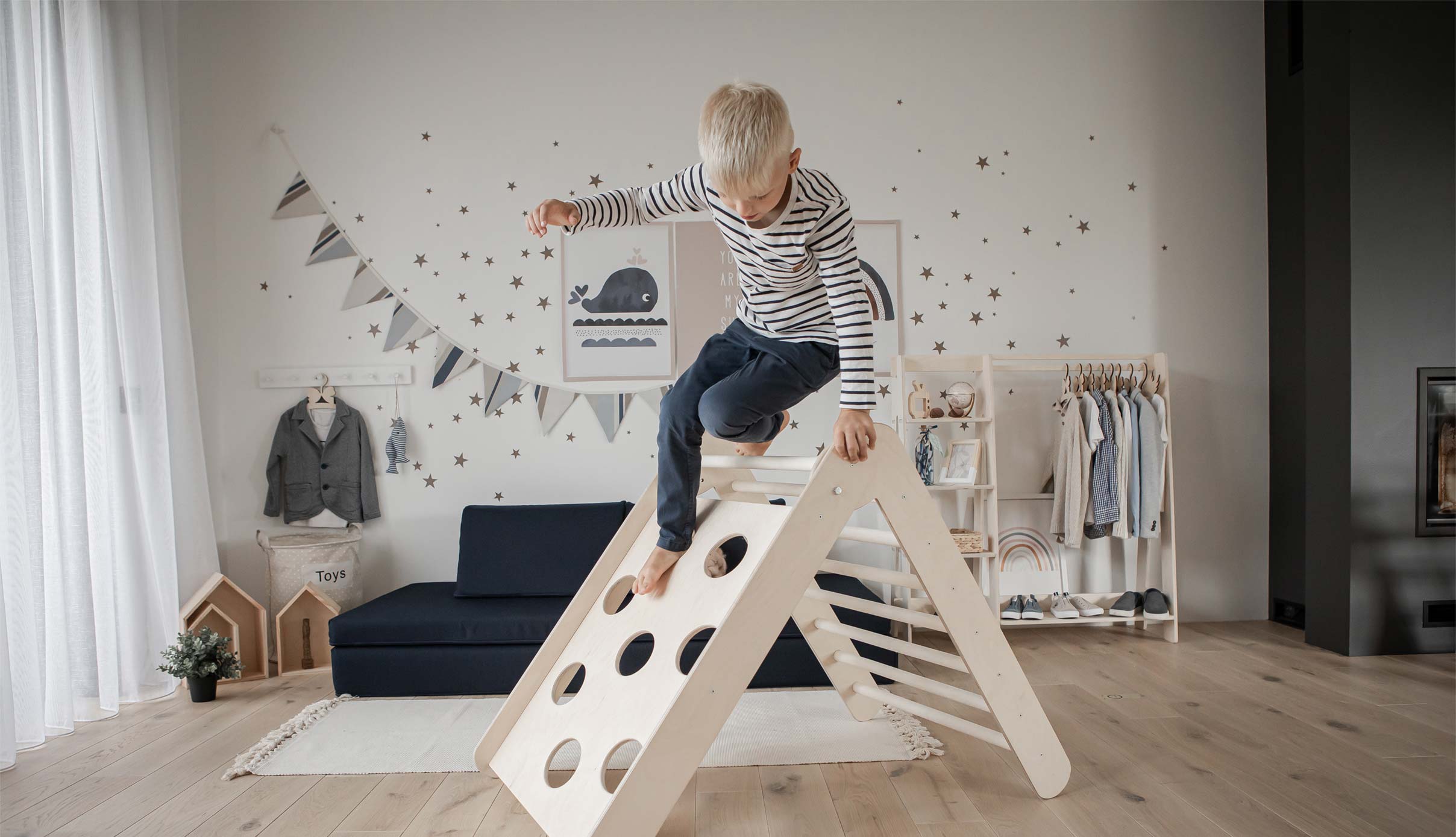A boy is playing with a wooden toy in a room.