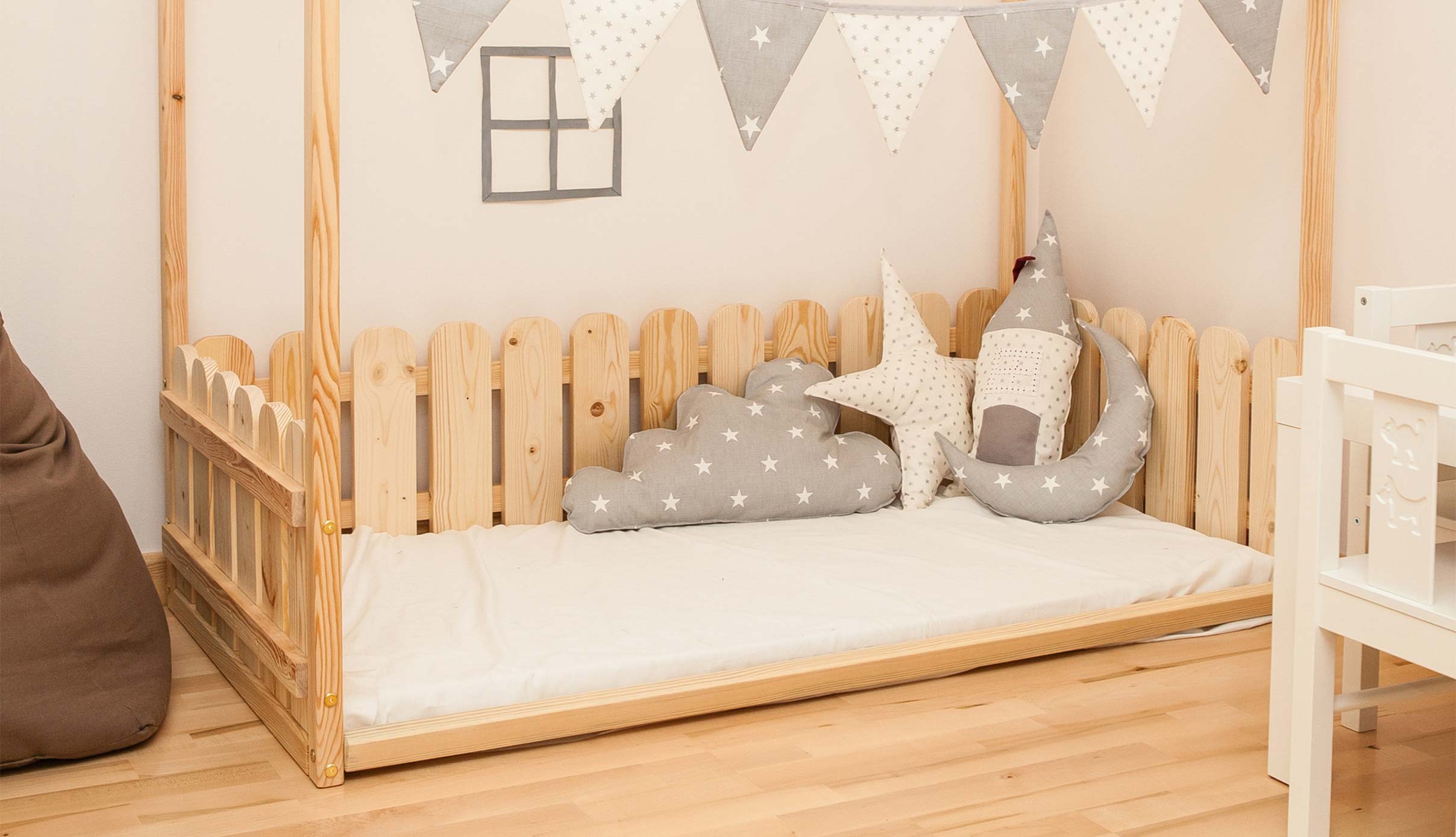 A wooden canopy bed in a child's room.