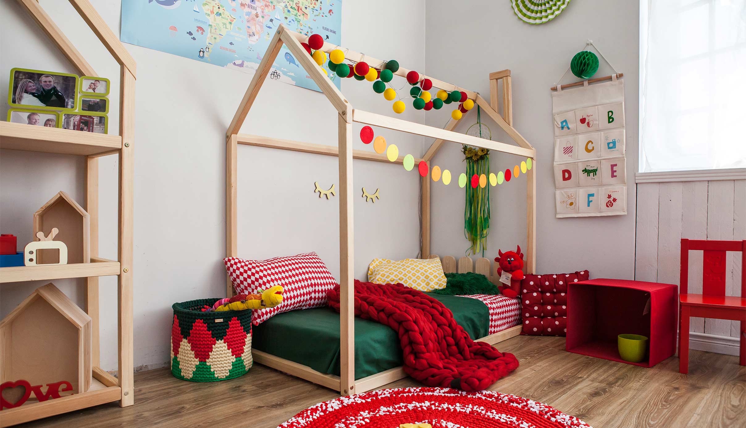 A children's room with a bed, toys and decorations.
