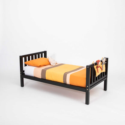 A Sweet Home From Wood raised kids' bed on legs with a headboard and footboard, made of solid wood and promoting independence.