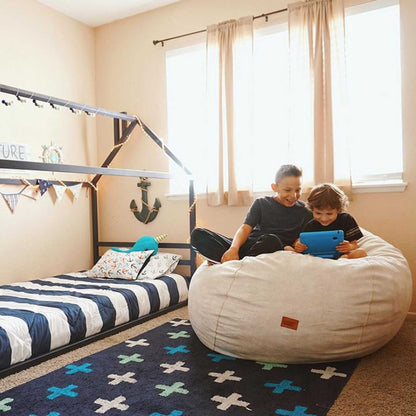 A boy and a girl enjoying the cozy comfort of a Sweet Home From Wood Children's house bed with a horizontal headboard in a boy's room.