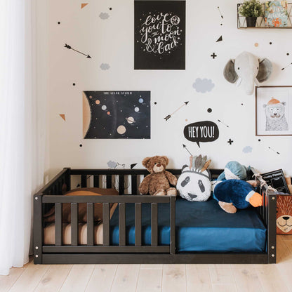 A child's room with independent sleeping and security, adorned with Montessori kids' bed with a fence from Sweet Home From Wood and teddy bears and stuffed animals.