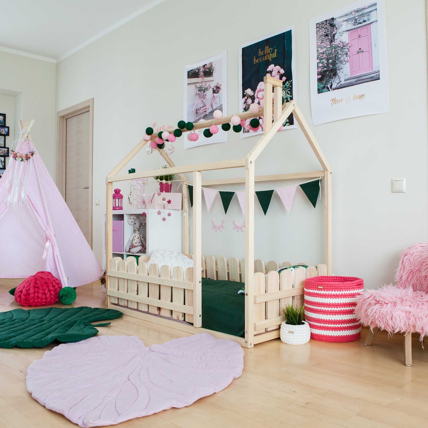 A girl's room with a Platform house bed with a picket fence designed as a teepee.