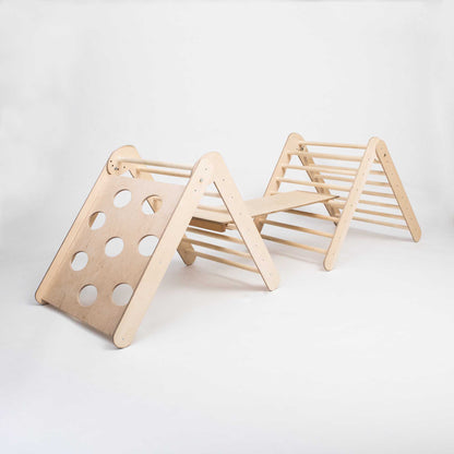 A wooden Transformable climbing triangle + Foldable climbing triangle + a ramp with holes on it, such as a triangle climber or wooden arch.