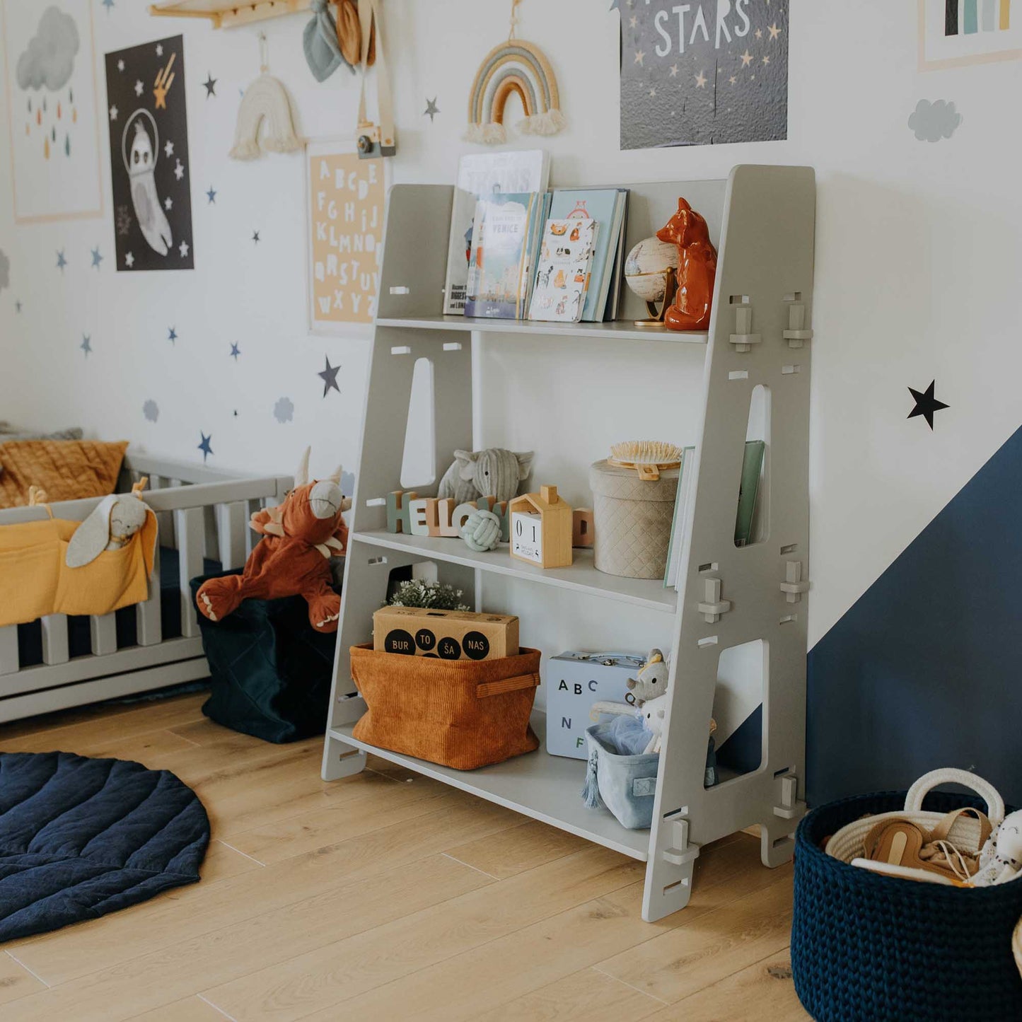 A child's room with a Sweet Home From Wood Montessori toy shelf.