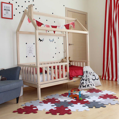 A Montessori-inspired child's room with a kids' house bed on legs with a fence.