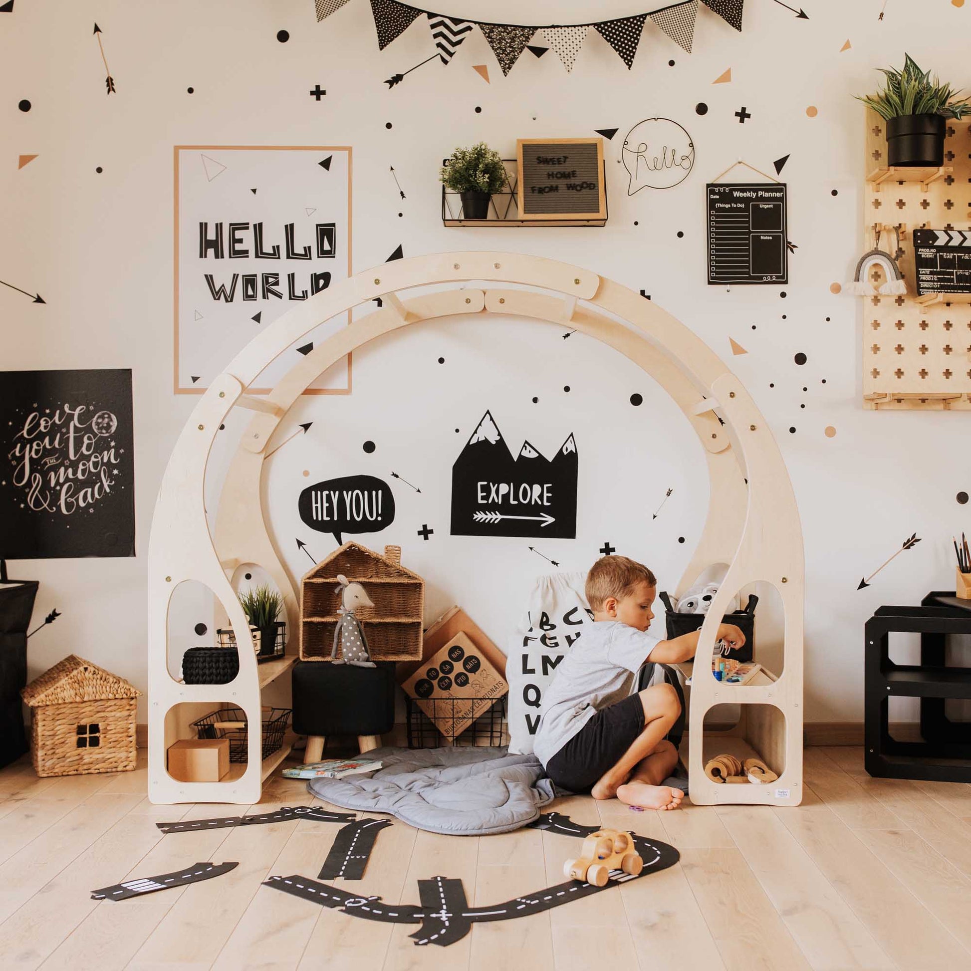 A child's playroom with a Sweet Home From Wood play stand for toddlers and a wooden arch.