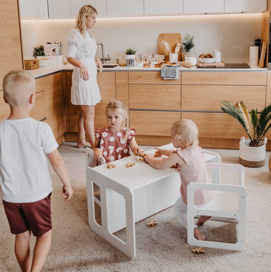 A family in a kitchen with a Montessori weaning table and 2 chair set from Sweet Home From Wood.