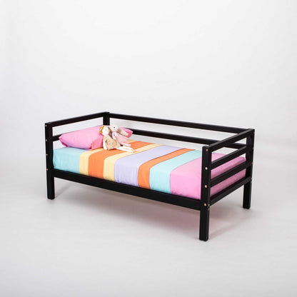 A Sweet Home From Wood Kids' bed on legs with a 3-sided horizontal rail that grows with your child and features a colorful striped sheet.