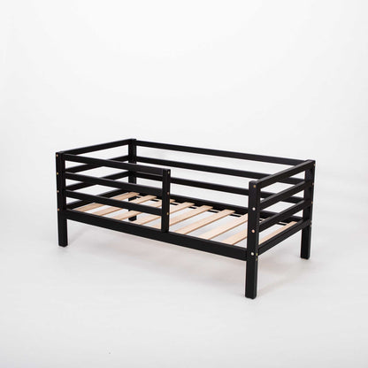 A Sweet Home From Wood Montessori-inspired black toddler bed featuring wooden slats.
