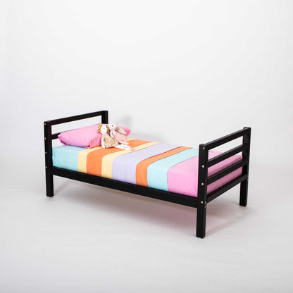 A Sweet Home From Wood kids' bed on legs with a horizontal rail headboard and footboard with a teddy bear on it.