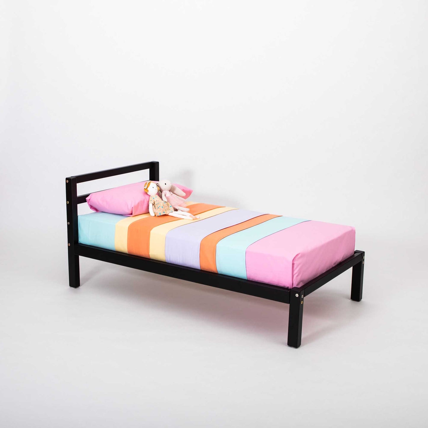 This Sweet Home From Wood 2-in-1 transformable kids' bed with a horizontal rail headboard features a design and is perfect for children as it grows with them. It showcases a vibrant and colorful bed sheet.