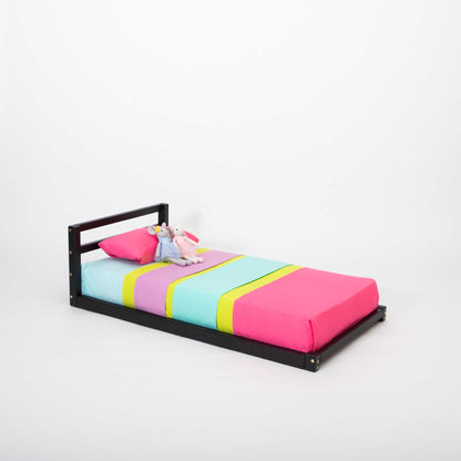 A Sweet Home From Wood 2-in-1 transformable kids' bed with a horizontal rail headboard that grows with the child, featuring a colorful bed sheet.