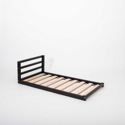 Toddler floor bed with a horizontal rail headboard